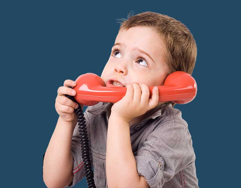 young boy using rotary phone prop in school photo