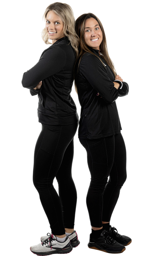 Two women dressed in black standing back to back.